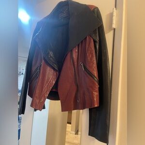 BCBGMaxazria black and burgundy hard leather jacket.